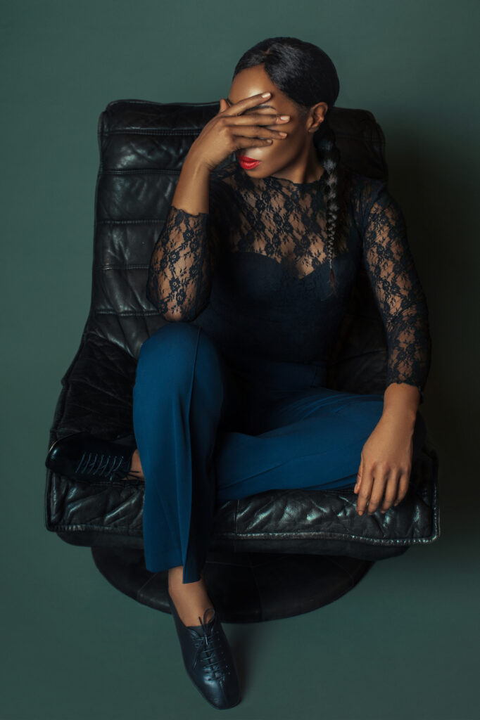 Shoe trends for spring. Elegant black woman sits down and is in thoughts.