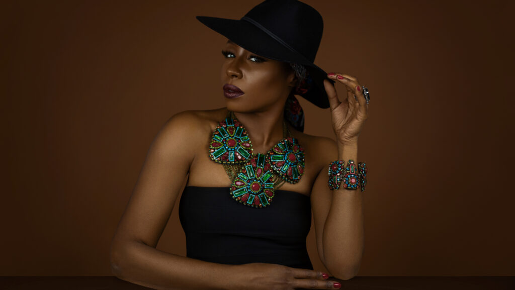 Gypsy Queens Editorial. Black model wearing a black hat and colorful Konplott jewelry