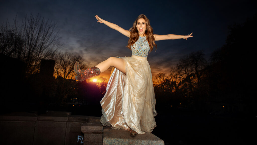 Britta Steffenhagen fashion editorial. Britta Steffenhagen standing on a bridge in Berlin wearing a summer dress and leather boots.