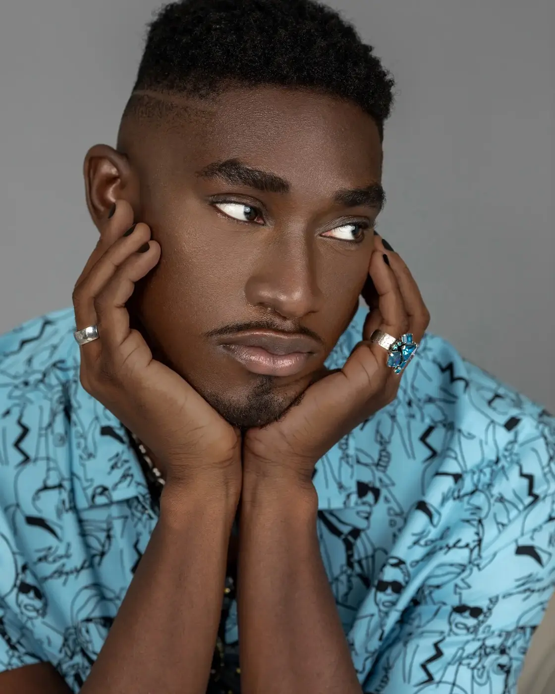 Beauty close-up with a blue shirt and layered jewelry