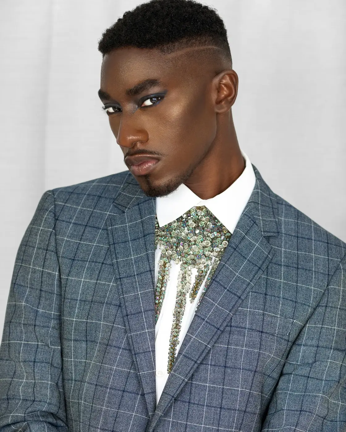 Beauty close-up with blue suit, white shirt and jewelry