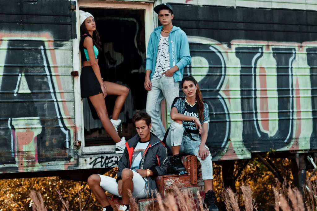 Four fashion models posing on a graffiti-covered trailer in Miami