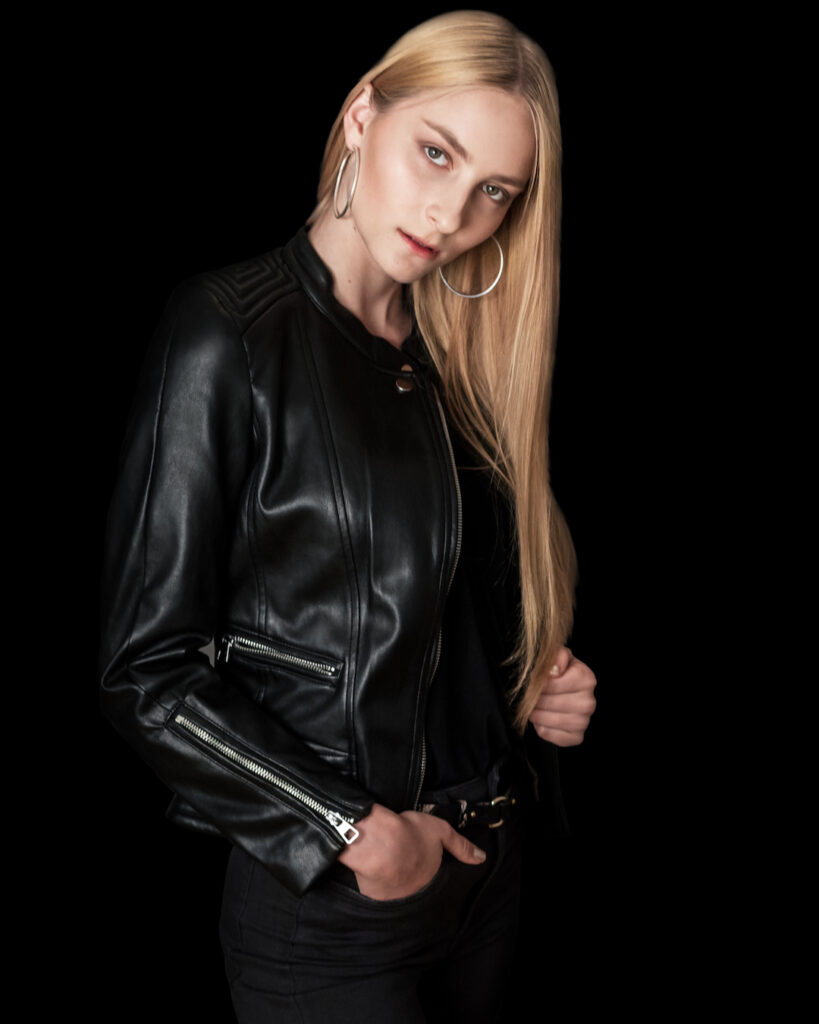 professional fashion photographer adjusting lighting for modeling portfolio session