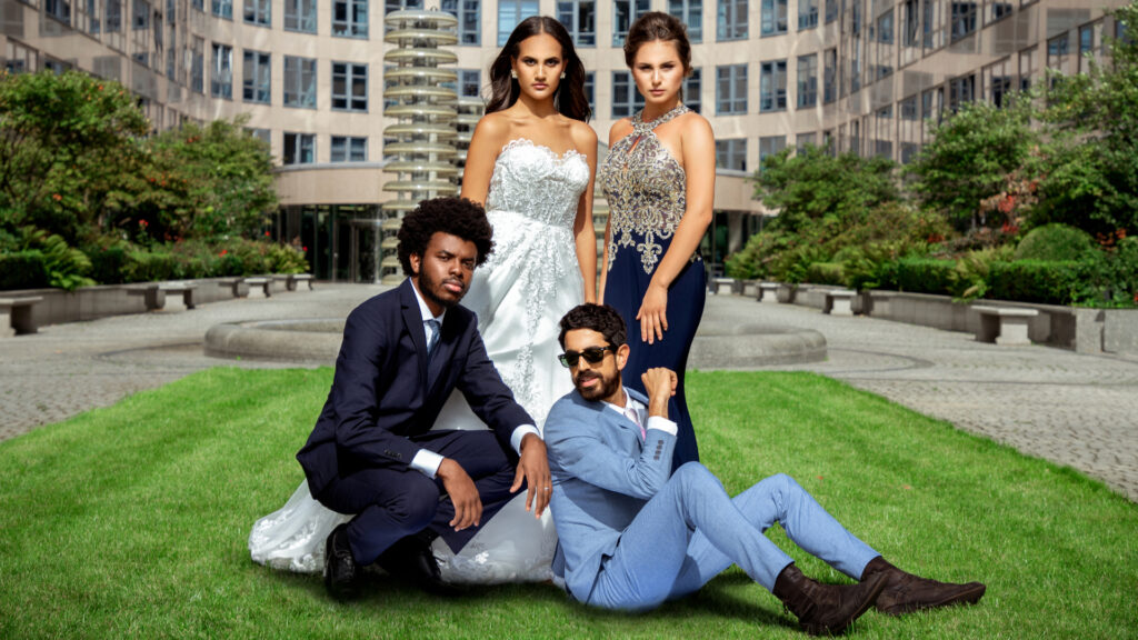 editorial wedding photography. Portrait of two interracial couples posing together on grass near a building, dressed in suits and wedding gowns.
