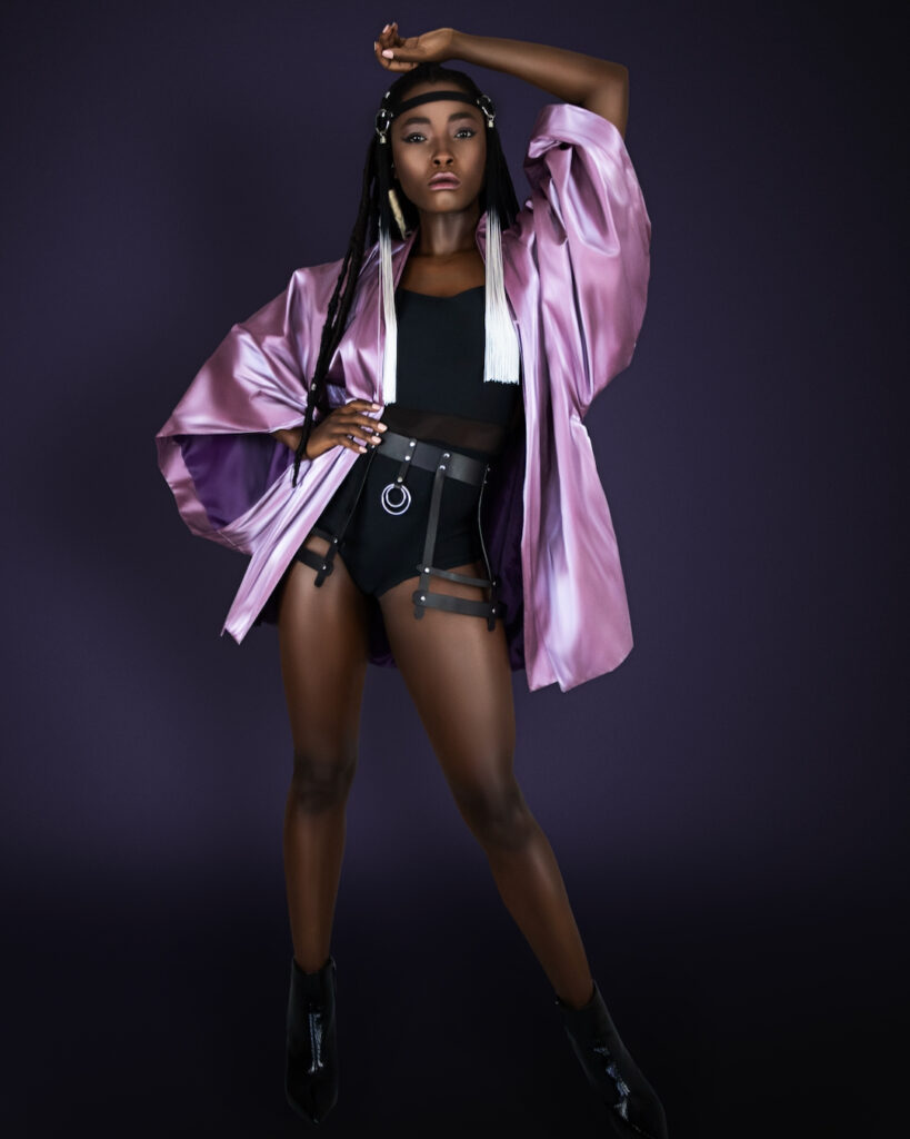 Avantgarde Fashion - Black woman wearing purple kimono, black bodysuit and leather belt