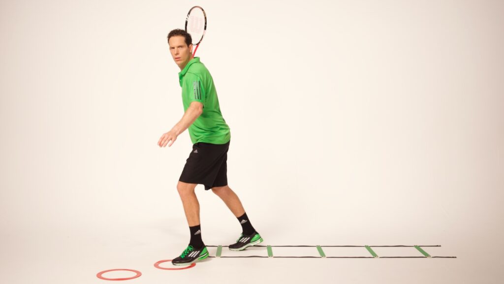 Professional performing advanced speed ladder patterns with eyes tracking an object.