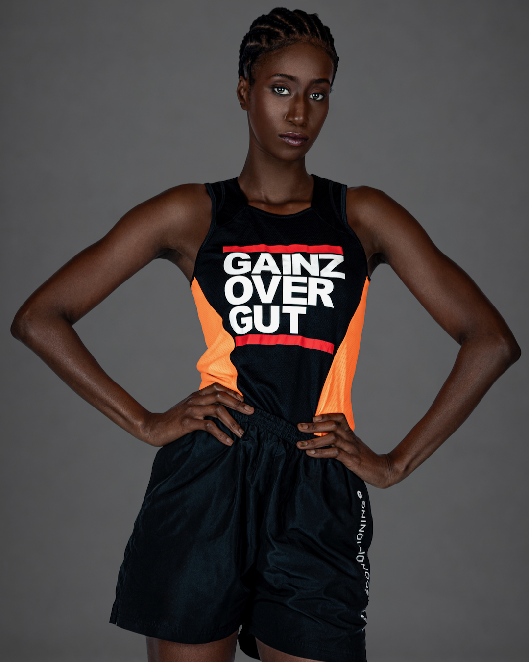 Gigi posing with arms raised in a contemporary athletic fashion editorial