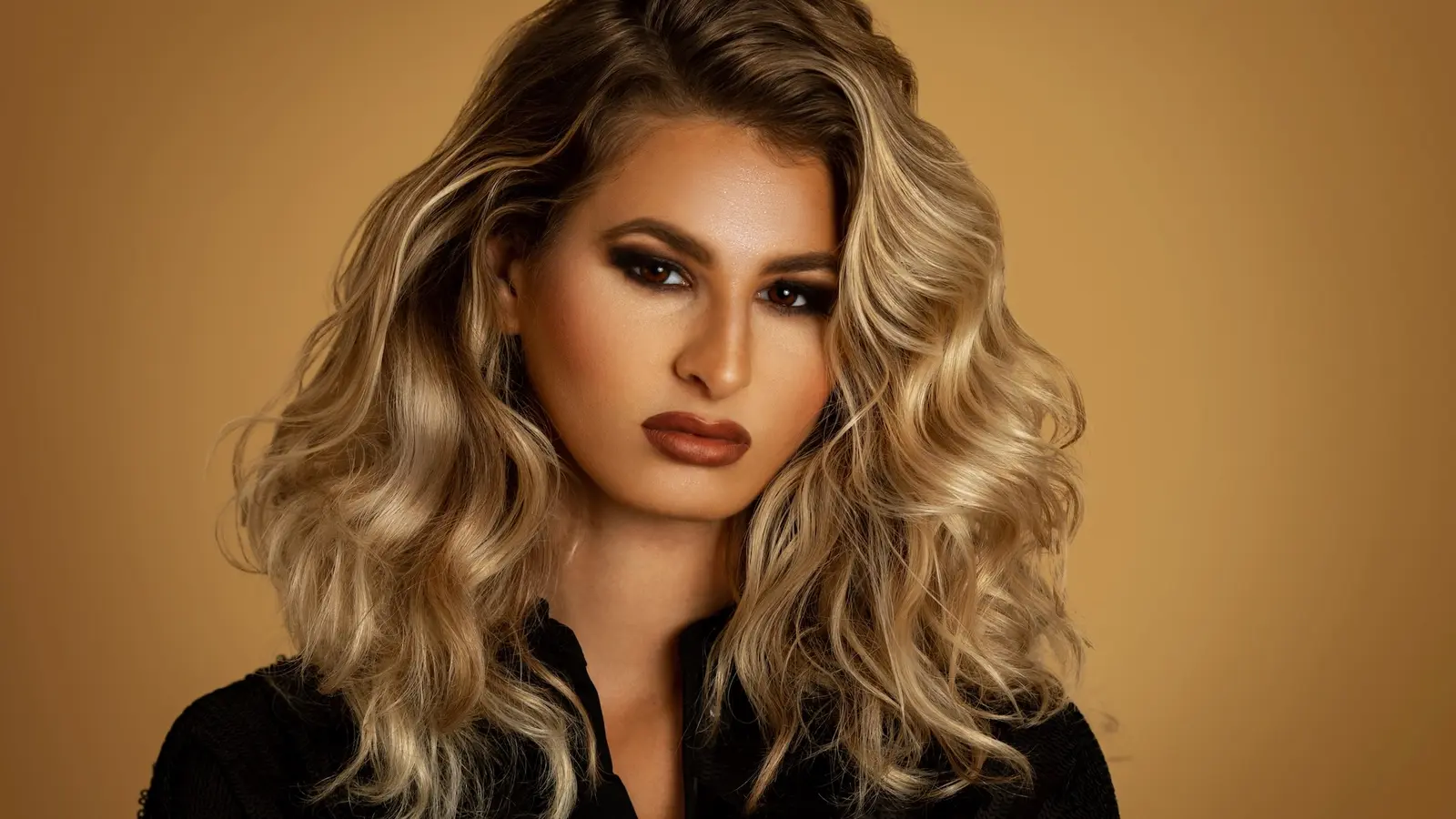 Female model in a polished beauty portrait with controlled studio lighting