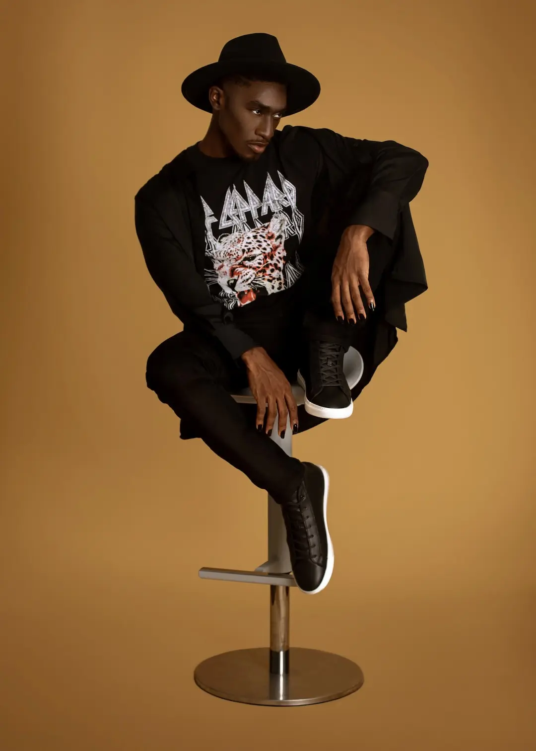 Full-length studio photograph showing a male model’s proportions and posture