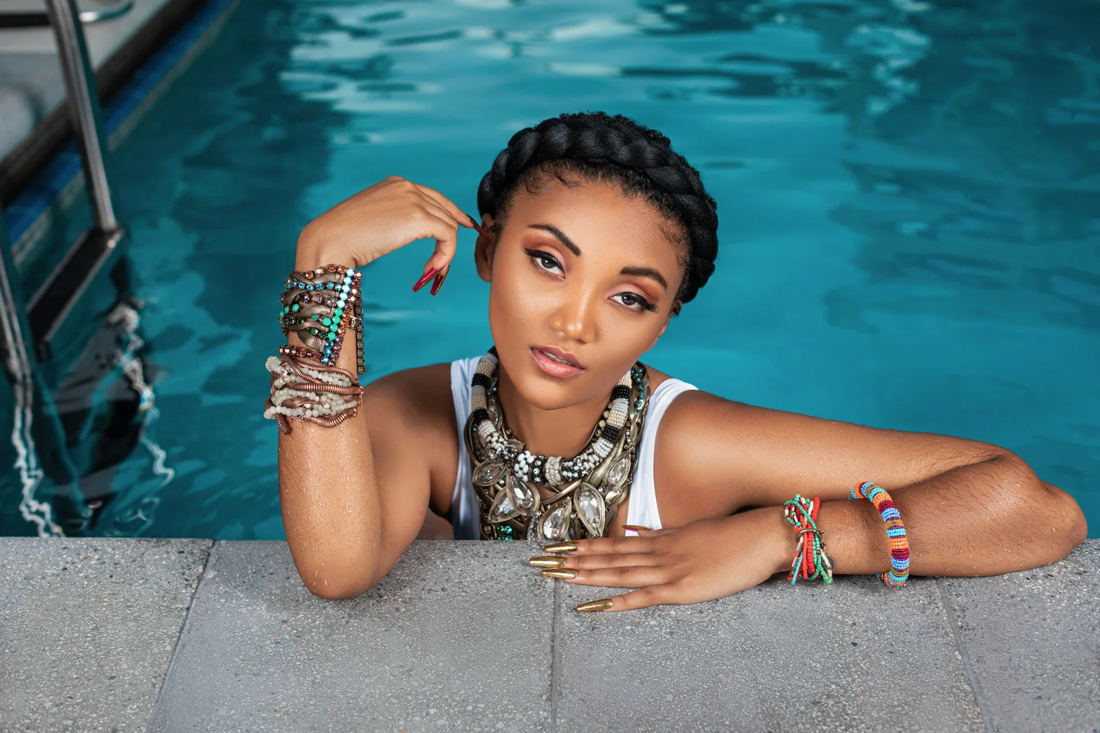 Close portrait of Jordan Kristine Seamon with jewelry and black and white swimwear