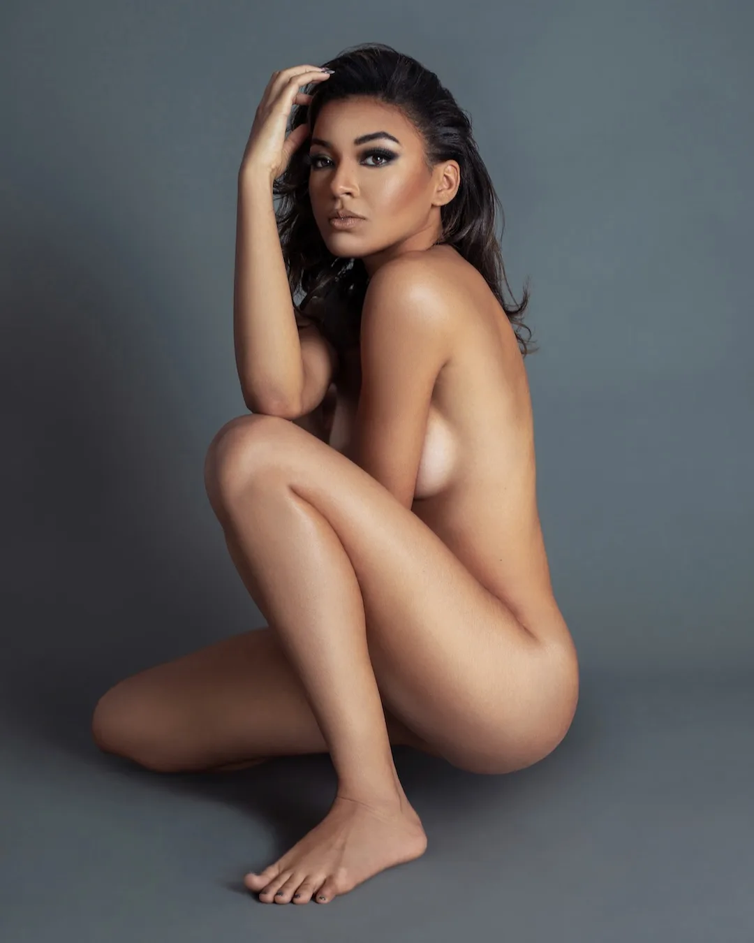 Fianna kneeling in an intimate portrait expressing soft strength