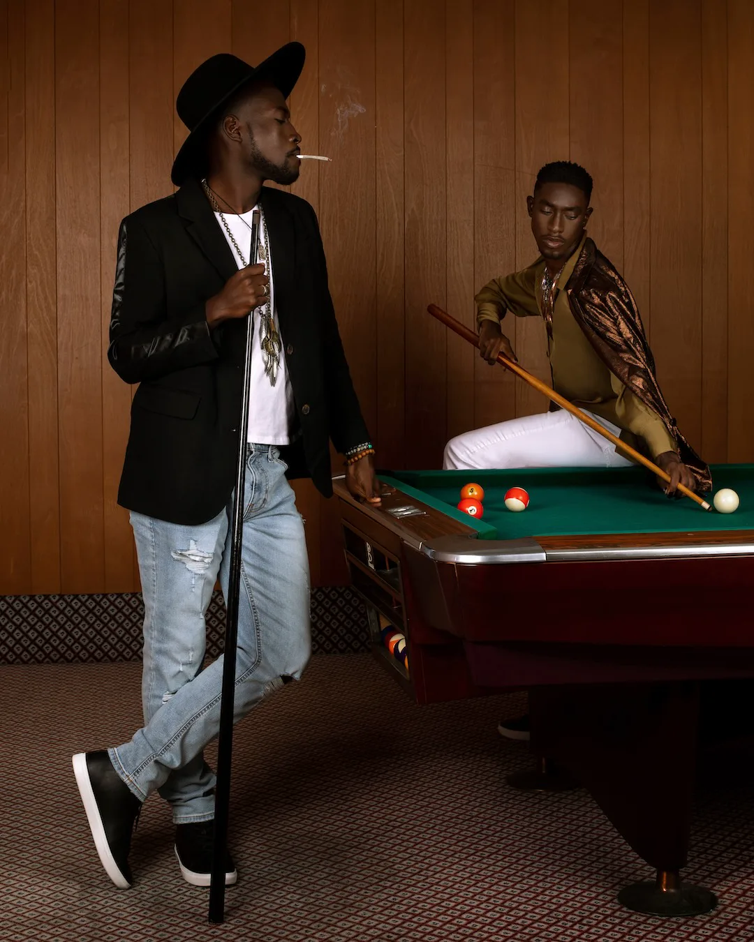 Two male friends spending relaxed time together at a billiards hall