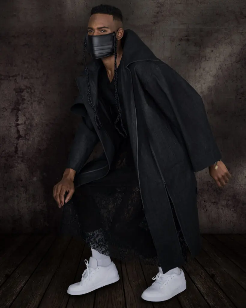Black male model in a denim coat, black dress and leather face mask