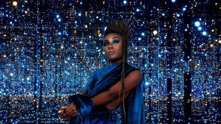 Black model in cobalt blue styling surrounded by mirrored blue lights