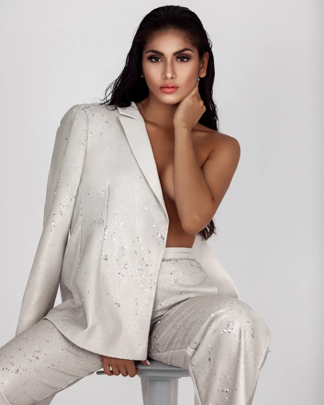 Model in a silver suit photographed for a confidence fashion editorial