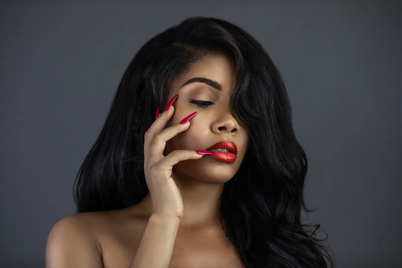 Woman with long dark hair and red lipstick in a casual simplicity fashion editorial