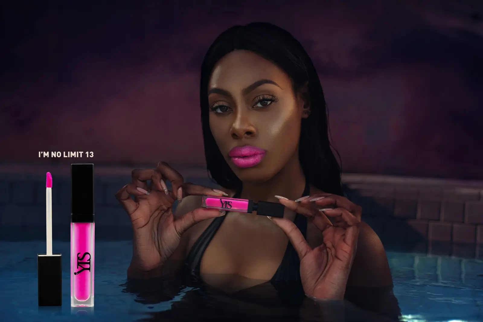 Model holding pink lipstick in a poolside beauty campaign composition