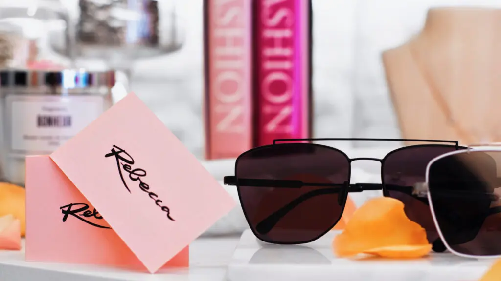 Rebecca Concept Store Berlin display with sunglasses, perfume and branded cards