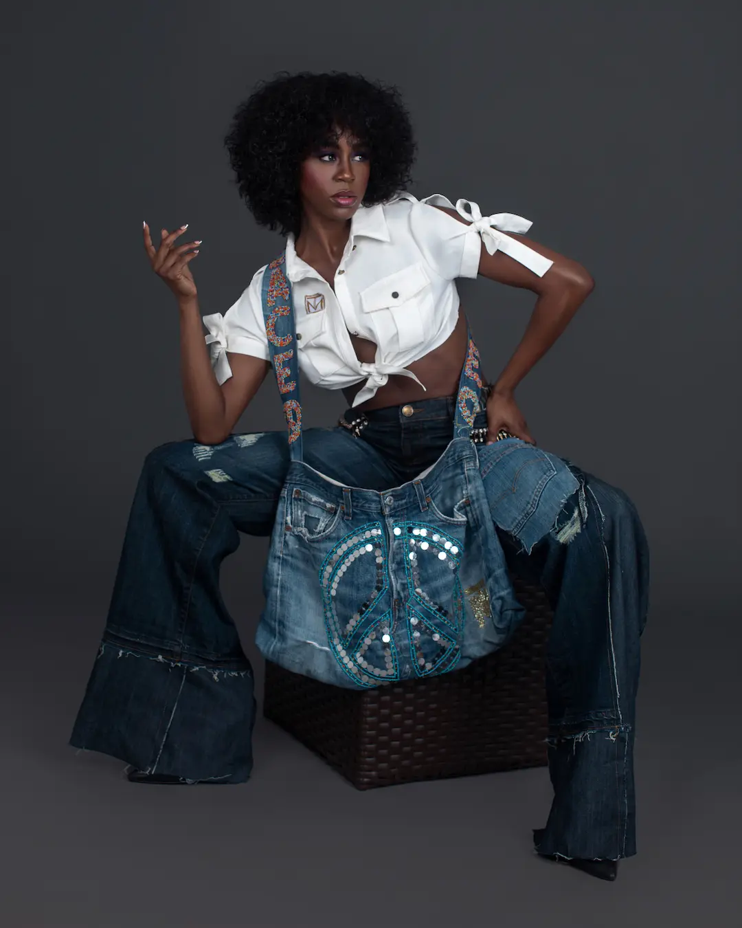 Jovona Logan in denim jeans, a white shirt and black heels