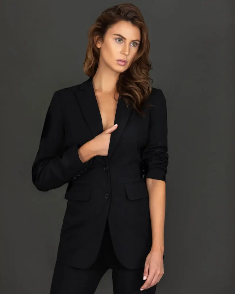 Rebecca posing in a black suit for a timeless studio fashion portrait