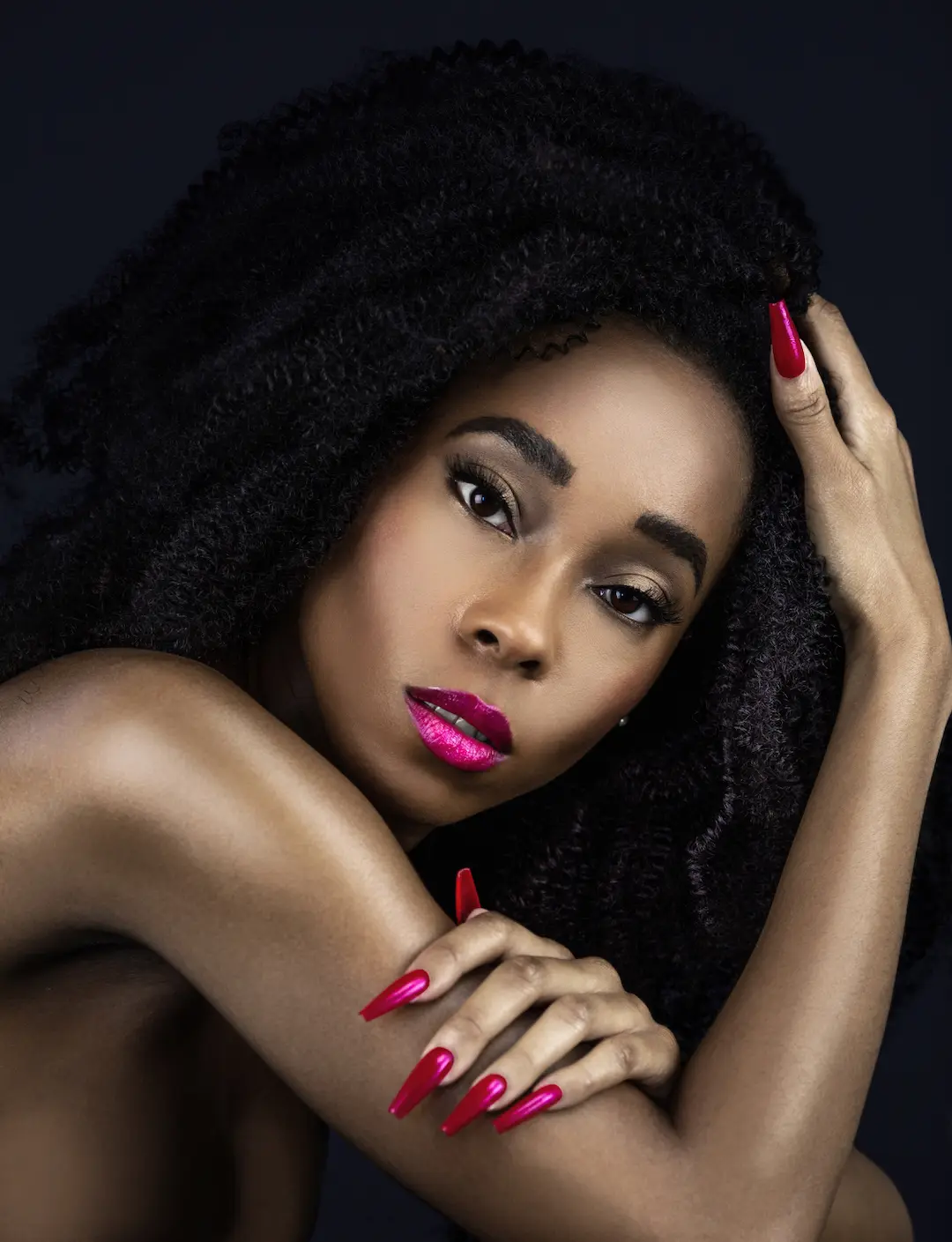 Understated elegance beauty portrait with natural curls and fuchsia lipstick